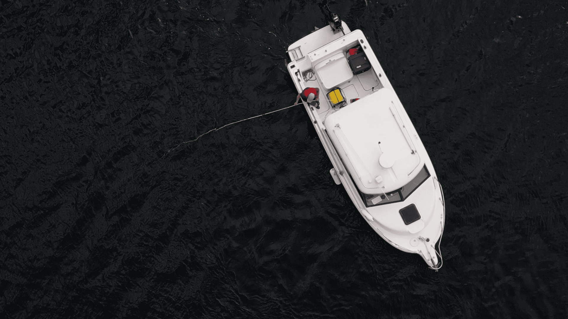  Drone shot showing boat in the middle of vast water and ideally ROV in water (or, location mapping path on controller screen)